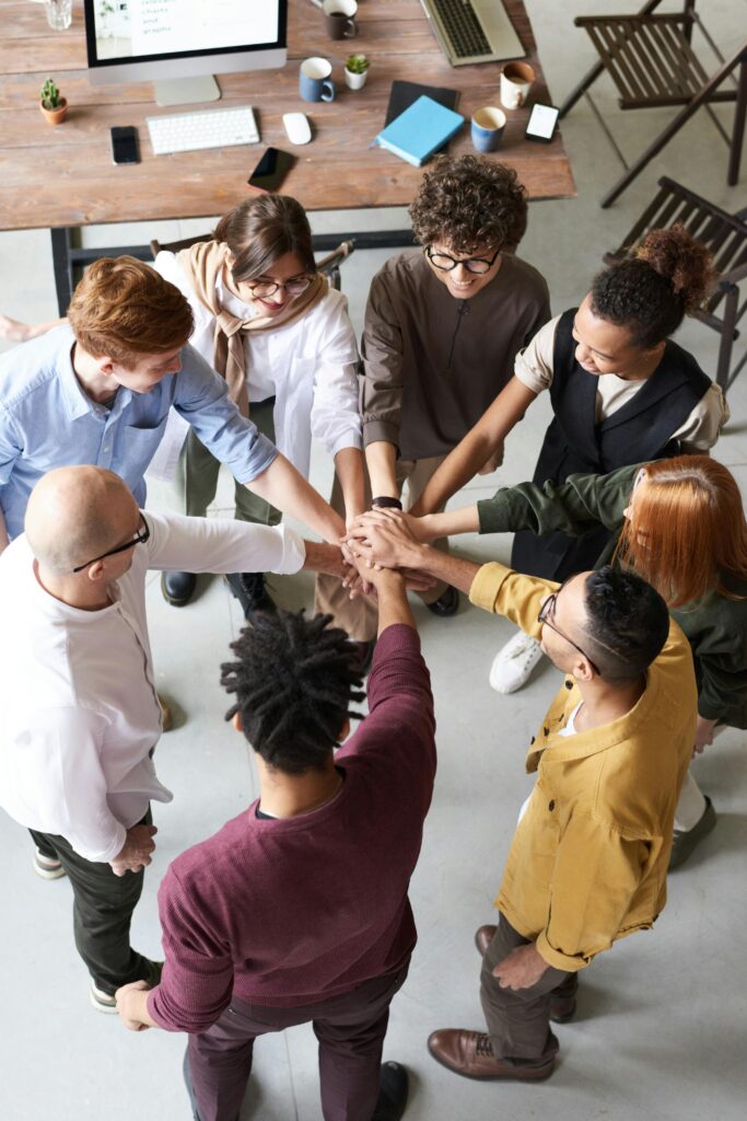 Group of people mingling with hands touching in a circle